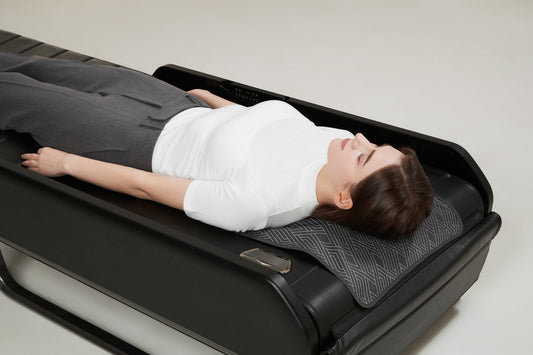Woman lying on a Ceragem Master V7 thermal massage bed