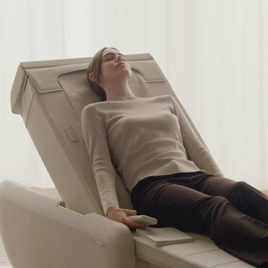 Woman reclining, reading and resting on the Ceragem Master V9