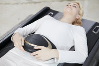 Person lying on the Ceragem Master V4 with the abdominal massager