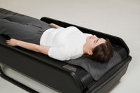Person lying on the Ceragem Master V7 during a session
